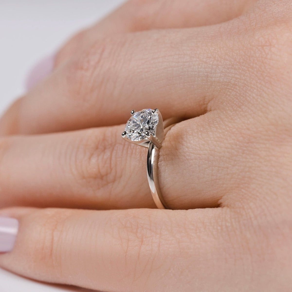 1 carat solitaire lab-grown diamond engagement ring in 14K white gold on hand in sizes $5, 5.5, 6, 6.5, 6.75, 7, 8$